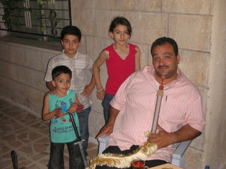 Khalil and his three children, enjoying the cool night air after dinner