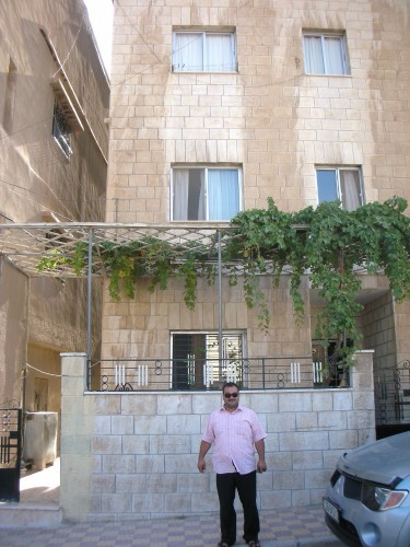 Khalil proudly presents family's grape-adorned building to me