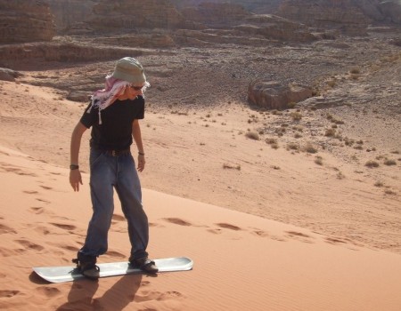Merely wearing a keffiyeh does not make you as skilled a sandboarder as a Bedouin.