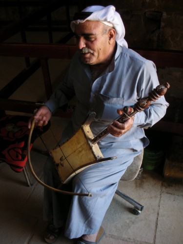 The elderly caretaker of the Umra Palace has a little merry-making of his own with the single-stringed Rababa