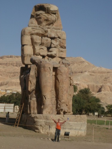 One of the twin Colossi of Memnon near the Nile shore, before entering the Valley. They think that the largest temples ever created was here, but was washed away because of its proximity to the Nile