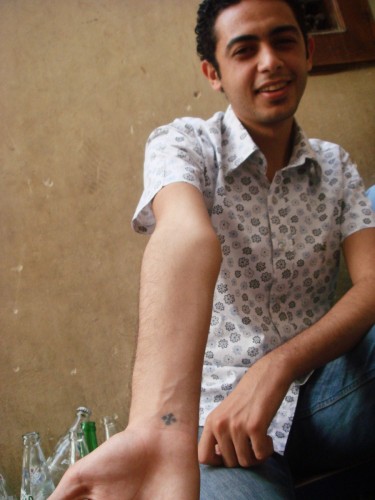 Jon shows off his wrist cross, a common tattoo among the Coptic sect. "I got it when I was five. It hurt - a LOT!"