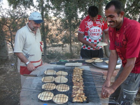 Abu Khalid and Ahmad the farm's guard grill the Ariys (flatbread with kebab meat inside) and shish tawooq (grilled and seasoned chicken chunks)